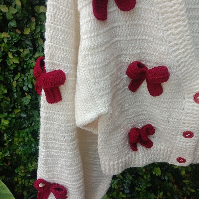 Off white cardigan with maroon bows